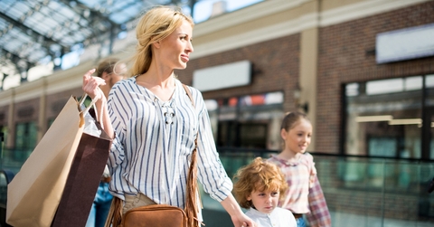 Blond woman shopping with kids at the mall