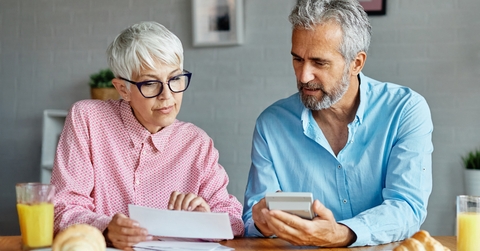 senior couple checking bills