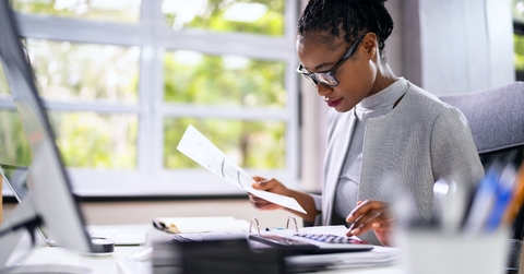 Woman working with her head down in bright office