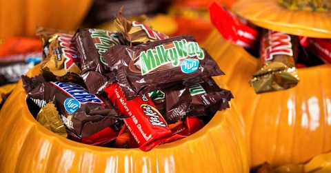 Decorative pumpkins filled with assorted Halloween candy