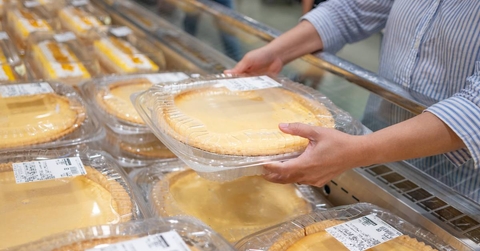 A shopper getting a pie from the grocery store