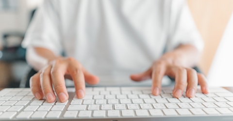Close up of hands on keyboard