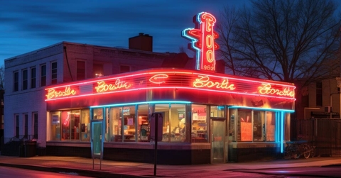 Classic neon sign glowing on a vintage diner facade