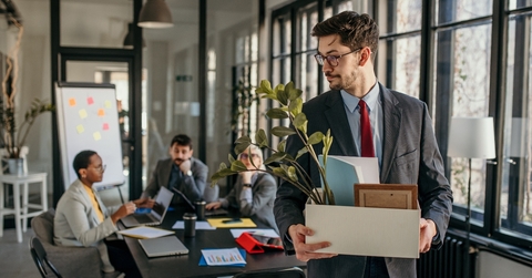 Man walking away fired from office job