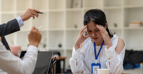 Female employee is scolded at office desk