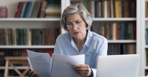 older woman reviewing papers