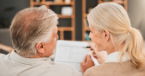 Older couple financial planning and looking at each other