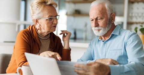 concerned couple reviewing bills