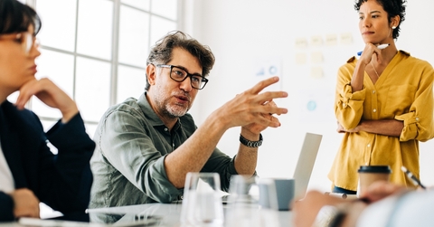 Mature man speaking in meeting