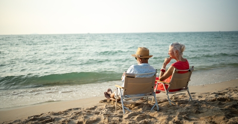 elderly sitting in chairs at the beach