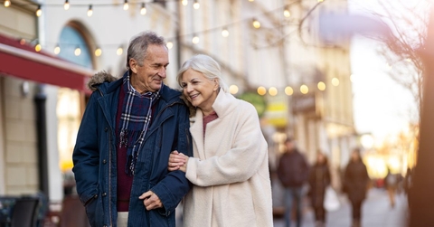 retired couple walking in city on a winter day