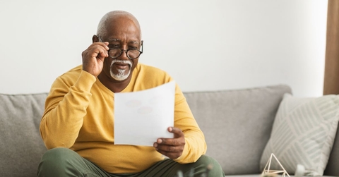 older man reviewing paper