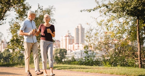 couple walking in summer city park