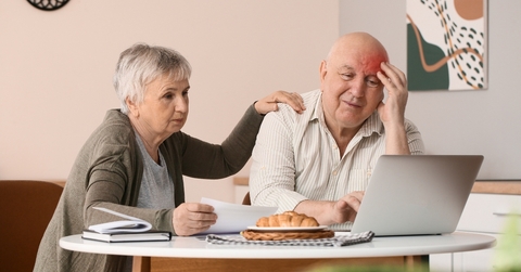 Older retired couple looking worried about bills