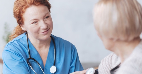 medical worker taking woman&#x27;s blood pressure