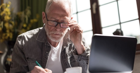 concentrated older man on laptop