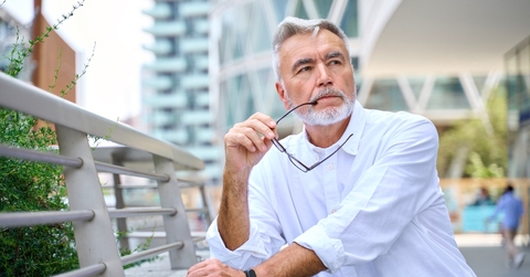 Older man in the city stop and thinking
