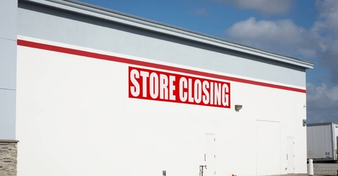 Store closing sign on building