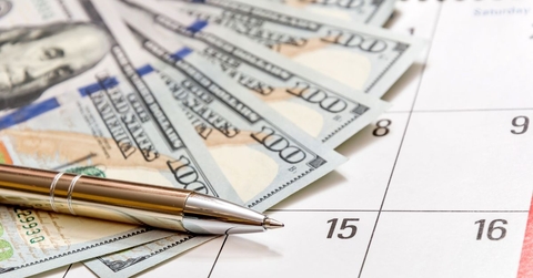pen with money on a calendar