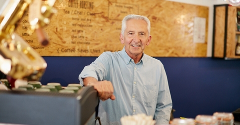 An old man working at a coffee shop