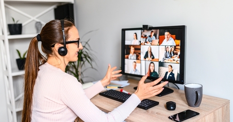 Woman working from home having a zoom meeting with several people