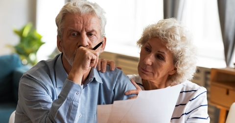 Older couple looking at paperwork worried
