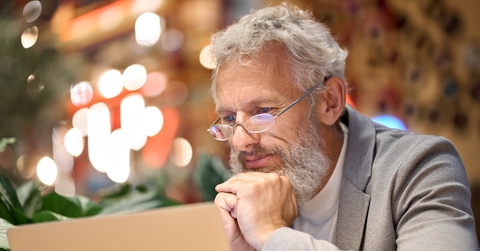 Older man reading something on the computer screen