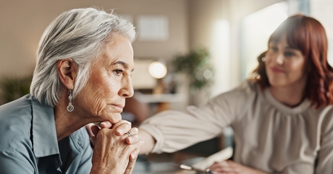 Senior woman sad being consoled by younger woman