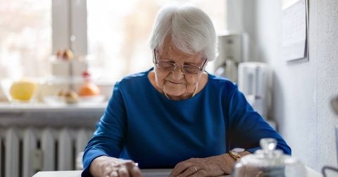 Senior woman filling out financial statements