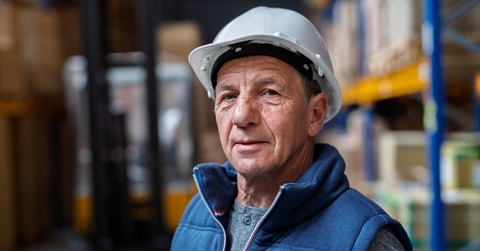 Mature warehouse worker with helmet