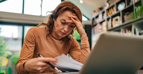 Woman looking stressed over finances