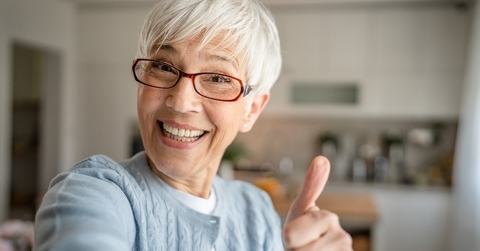 An older woman with a thumbs up