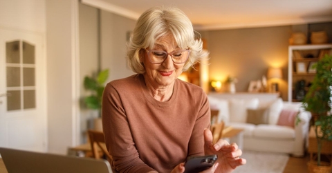 Retired woman smiling on cellphone