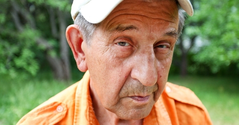 Sly older man looking at camera