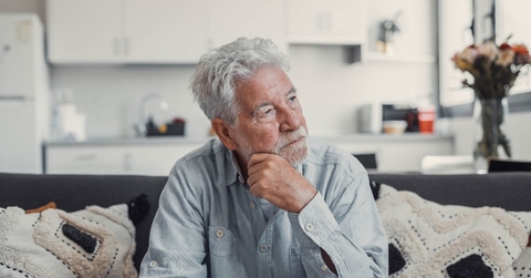 Contemplative older man on couch
