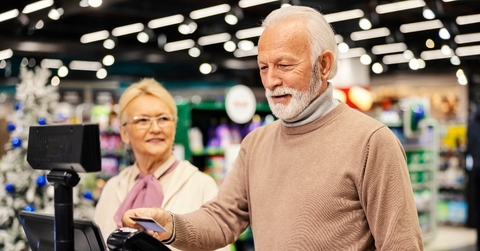 Elderly couple paying at the grocery store