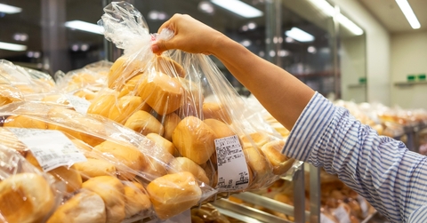 Costco Bakery shopper grabs a bag of bread rolls