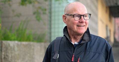 Smiling man in his 60s walking in the city