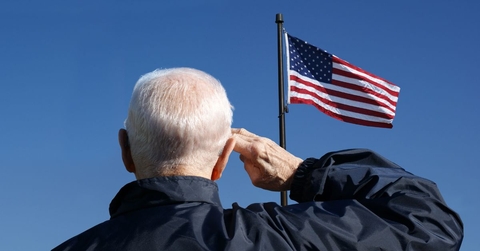 Veteran saluting the American flag