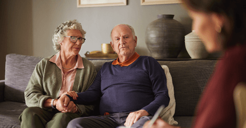 Couple looking pensive talking with advisor