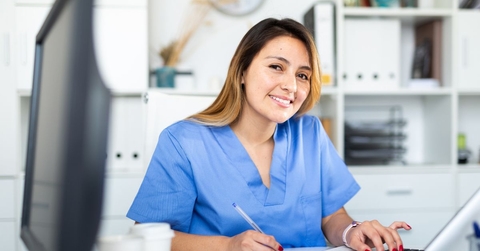 Female physician assistant working at desk