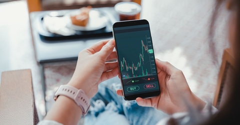 Woman looking at an investing app on her phone