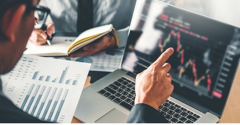 Businessmen analyzing stocks