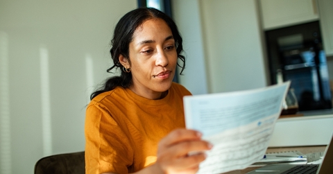 Woman looking at tax document