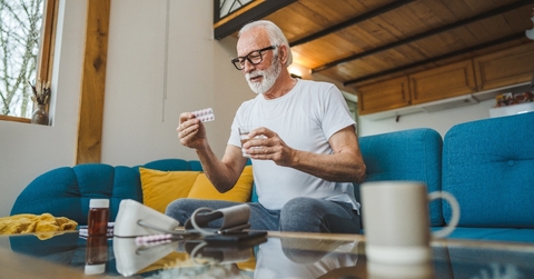 Senior man taking his medication