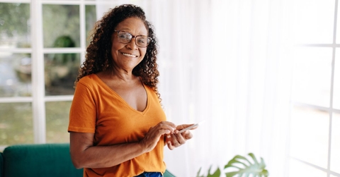 Smiling older woman in an orange top