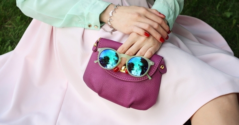 Woman holding bag and sunglasses