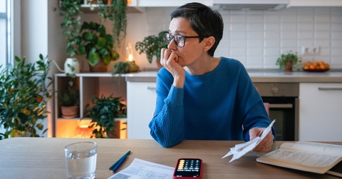 Woman looking worried about debt and bills