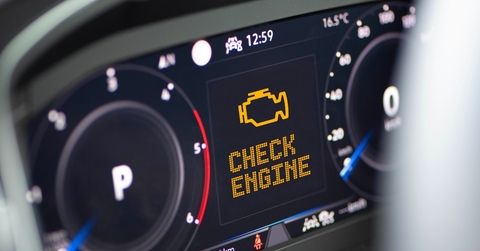 Car dashboard with engine light on