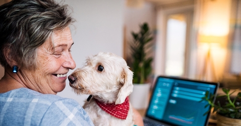 Senior with her dog and laptop